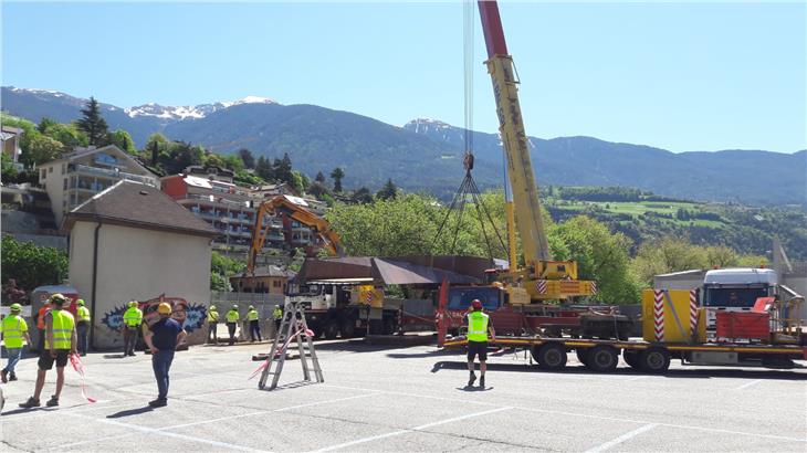 Am Vormittag begannen die Arbeiten zum Aufbau der in vier Teilen angelieferten Fußgängerbrücke über den Eisack auf dem Parkplatz Priel in Brixen. (Foto: LPA/Florian Knollseisen)